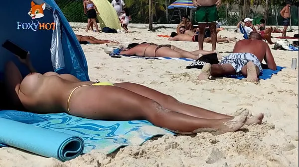 Ny Sunbathing topless on the beach to be watched by other men fresh tube
